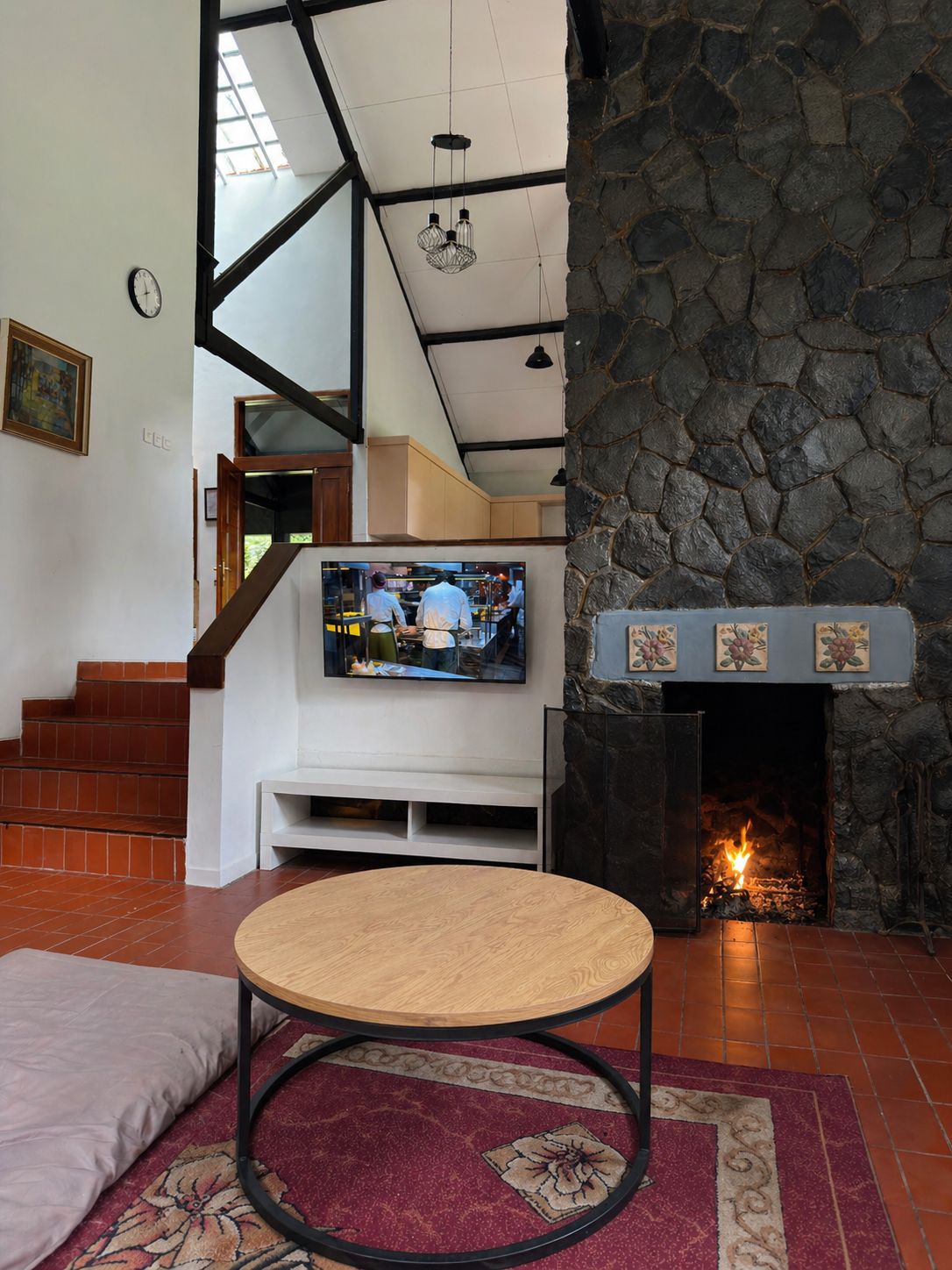 Living room with sofa, television, and fireplace